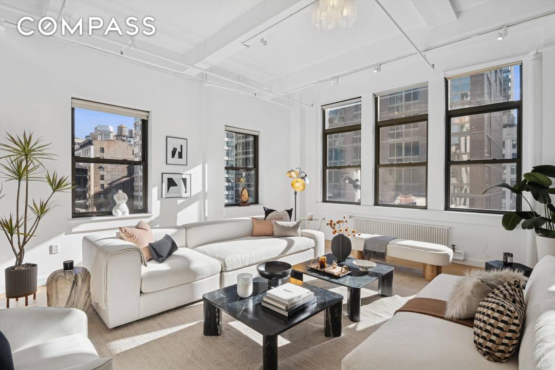 Spectacular sprawling full floor LOFT with 12 foot ceilings and 30 oversized windows facing north, south, east and west, showering the apartment with light all day.