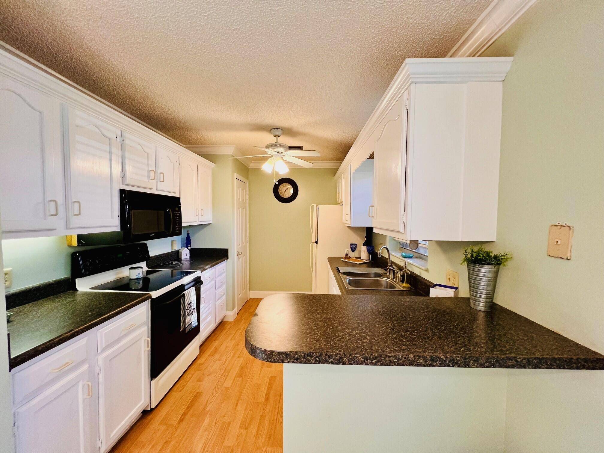 Enjoy the Over 55 lifestyle in this two bedroom, two bath, first floor, corner unit condo that is very close to the community clubhouse, pool, tennis, shuffleboard and more !