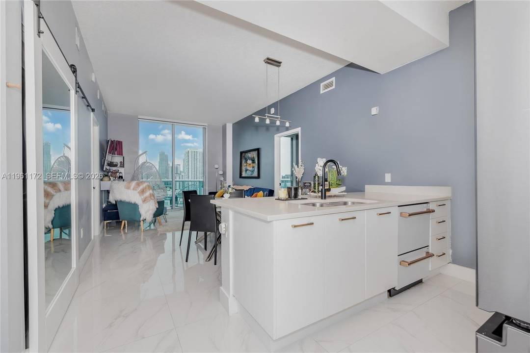 Modern living meets city energy in this beautifully remodeled 2 2 Den condo in sought after Edgewater.
