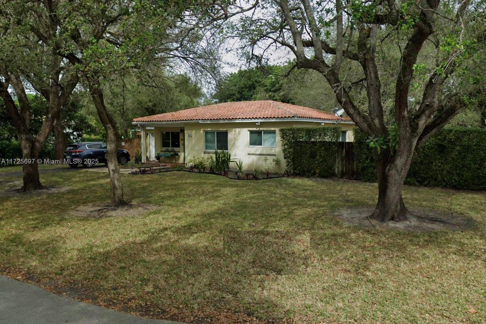 South Miami corner house, with Many mature trees providing excellent shade, intact terrazzo floors, one car garage, paved driveway, and a fantastic location close to everything.