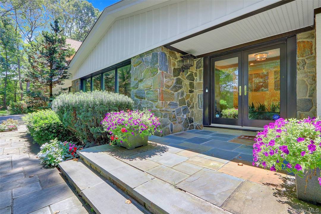 Welcome to Tree Tops an expansive, newly renovated and expanded California style luxury ranch set on three serene acres in the heart of Mill Neck.