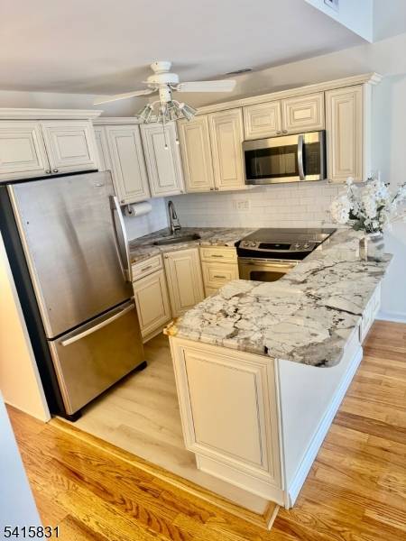 Step onto NEWLY REFINISHED HARDWOOD FLOORS that flow through an expansive living room, positioned for relaxation and leading out to a Large PRIVATE balcony.