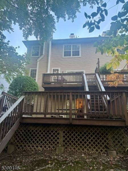 Well maintained end unit with a two tiered deck overlooking the woods.