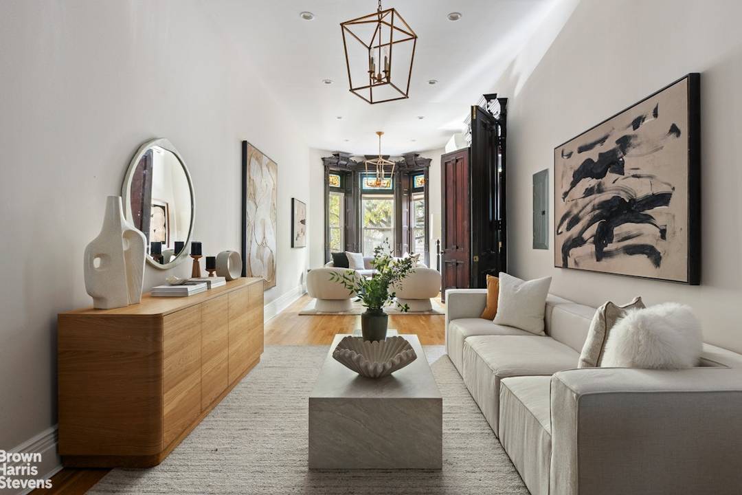 The moment this exquisite single family brownstone comes into view, its ornate facade and rich architectural detailing immediately capture the eye.