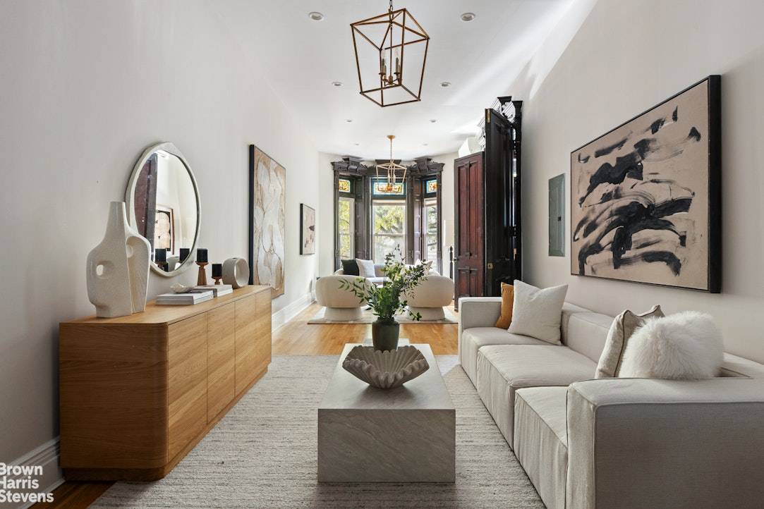 The moment this exquisite single family brownstone comes into view, its ornate facade and rich architectural detailing immediately capture the eye.