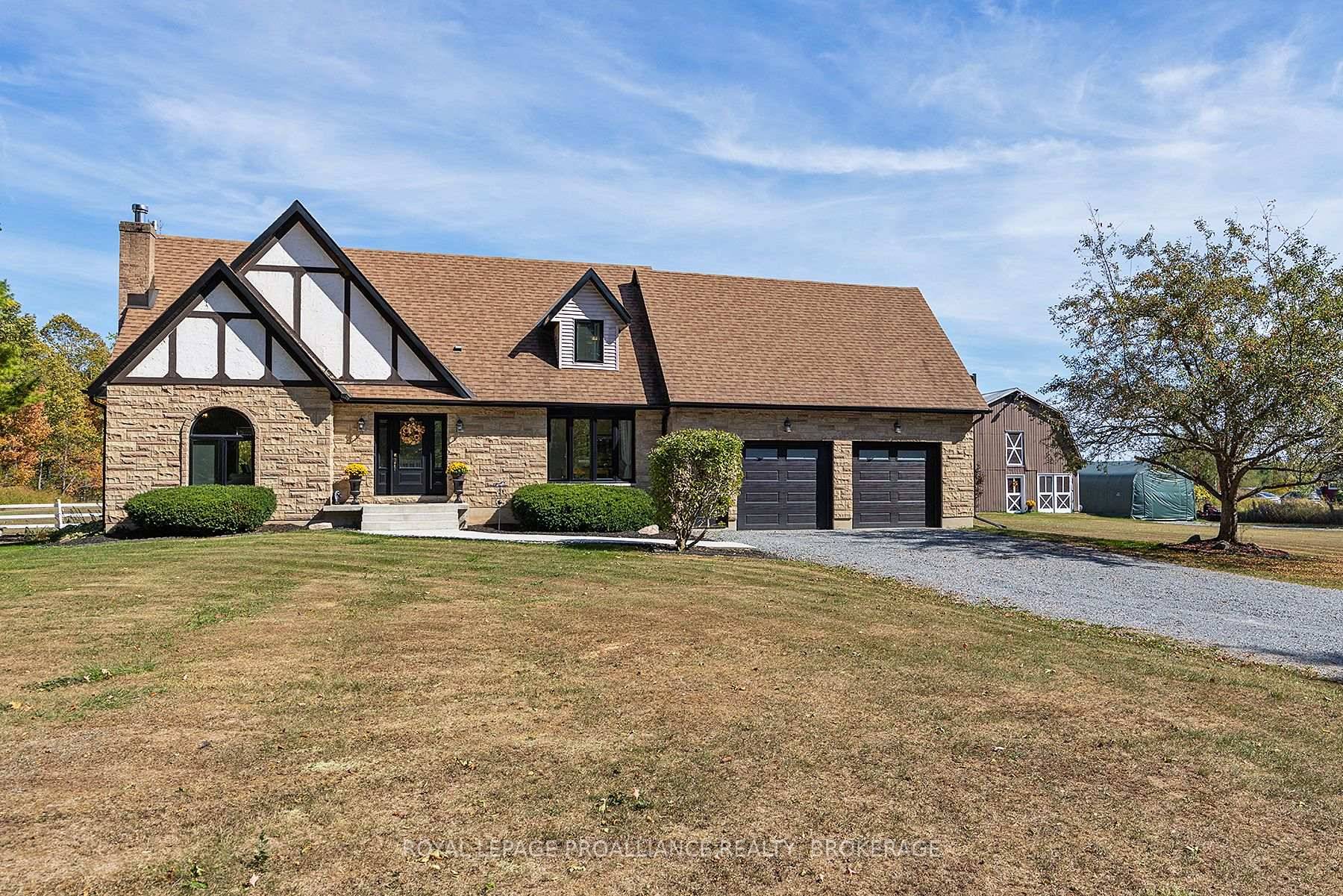 Elegant Tudor style residence nestled on over 3 acres, surrounded by breathtaking natural beauty and storybook charm.