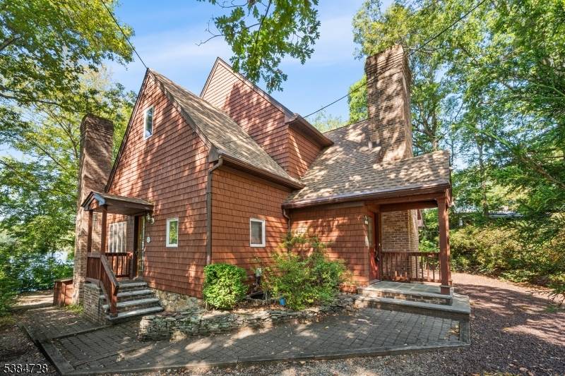 Experience the best of lakefront living in this spacious, custom home set directly on the shores of Cedar Lake.