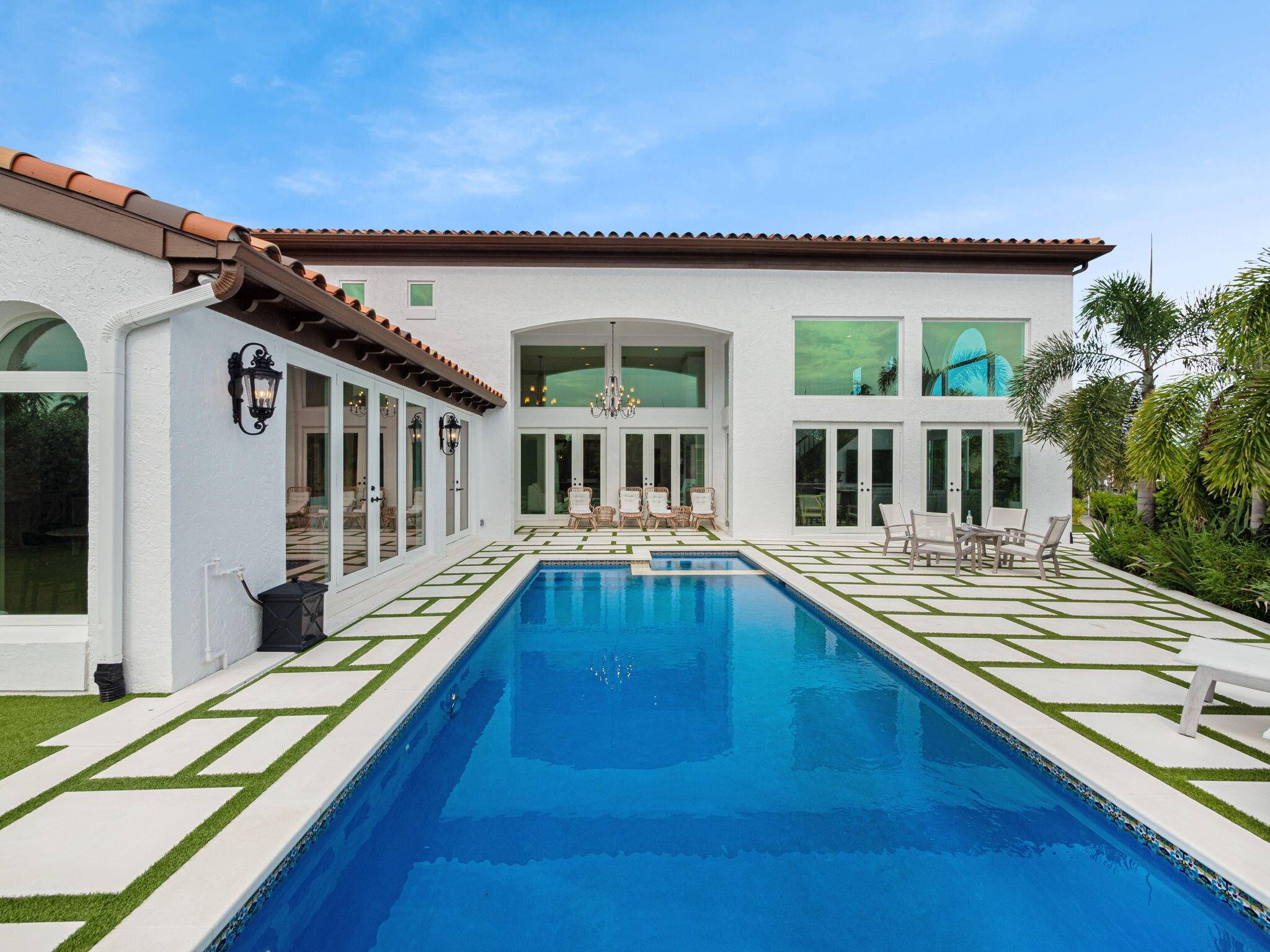 Welcome to 3299 Bridgegate Drive, a meticulously renovated deep waterfront pool home in the prestigious Jonathan's Landing Country Club, Jupiter Florida.