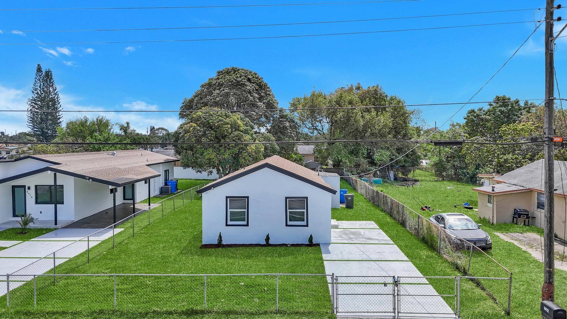 This beautifully updated home boasts an open floor plan with impact windows, neutral flooring, recessed lighting, and freshly painted walls, creating a bright and inviting space.