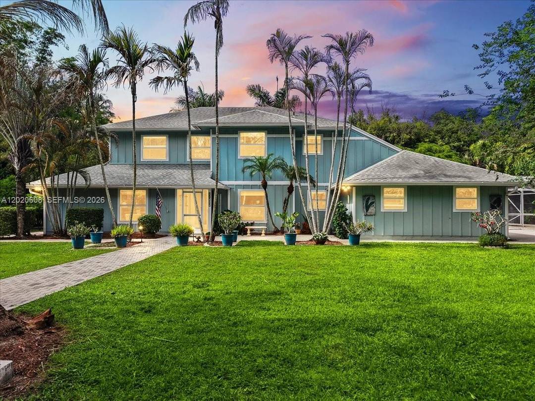 Experience the perfect blend of privacy, space, and country style living with this exceptional 2 story estate on nearly 1.