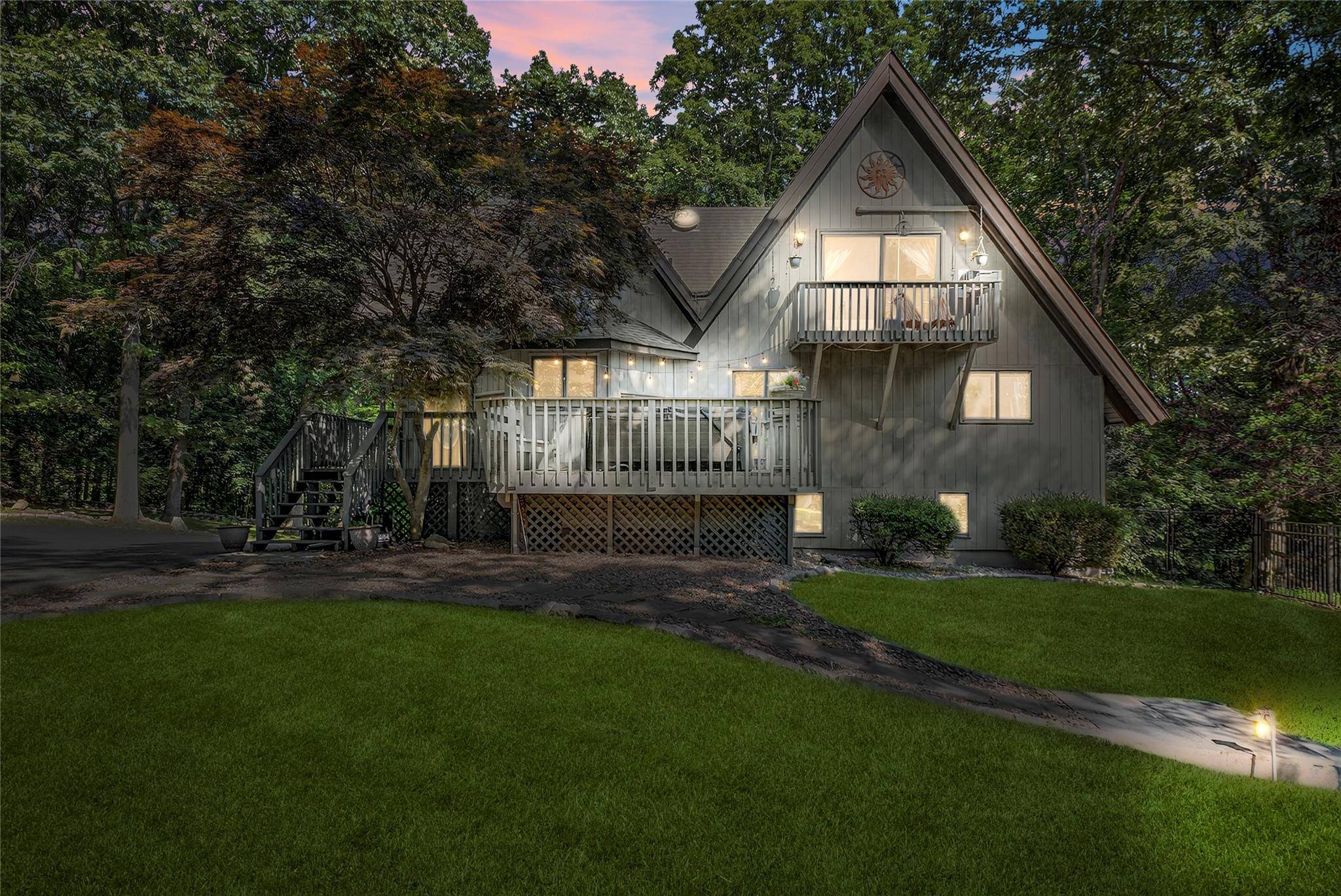 Nestled at the top of a tree lined driveway, this stunning three level contemporary chalet is a true private oasis, blending architectural elegance with natural serenity.