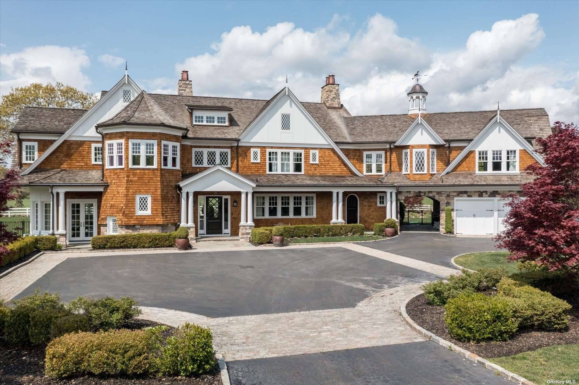 Nestled in a private and gated community, this exceptional estate sits on 2 pristine acres of land in highly sought after Hidden Pond, Old Westbury.