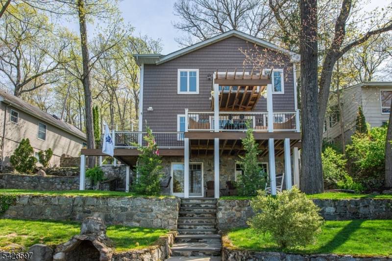 Completely rebuilt expanded in 2021, this exceptional high efficiency lakefront residence in Ringwood's coveted Erskine Lake community seamlessly blends modern luxury w timeless lakefront design an open concept floor plan ...