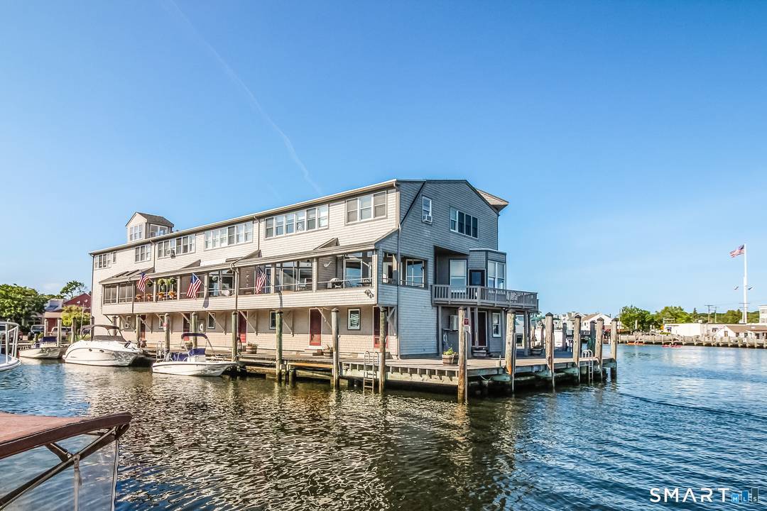 Direct Waterfront 2 Bedroom, 3 and 1 2 Bath Condo in Historic Downtown Mystic at the very desirable Steamboat Wharf.
