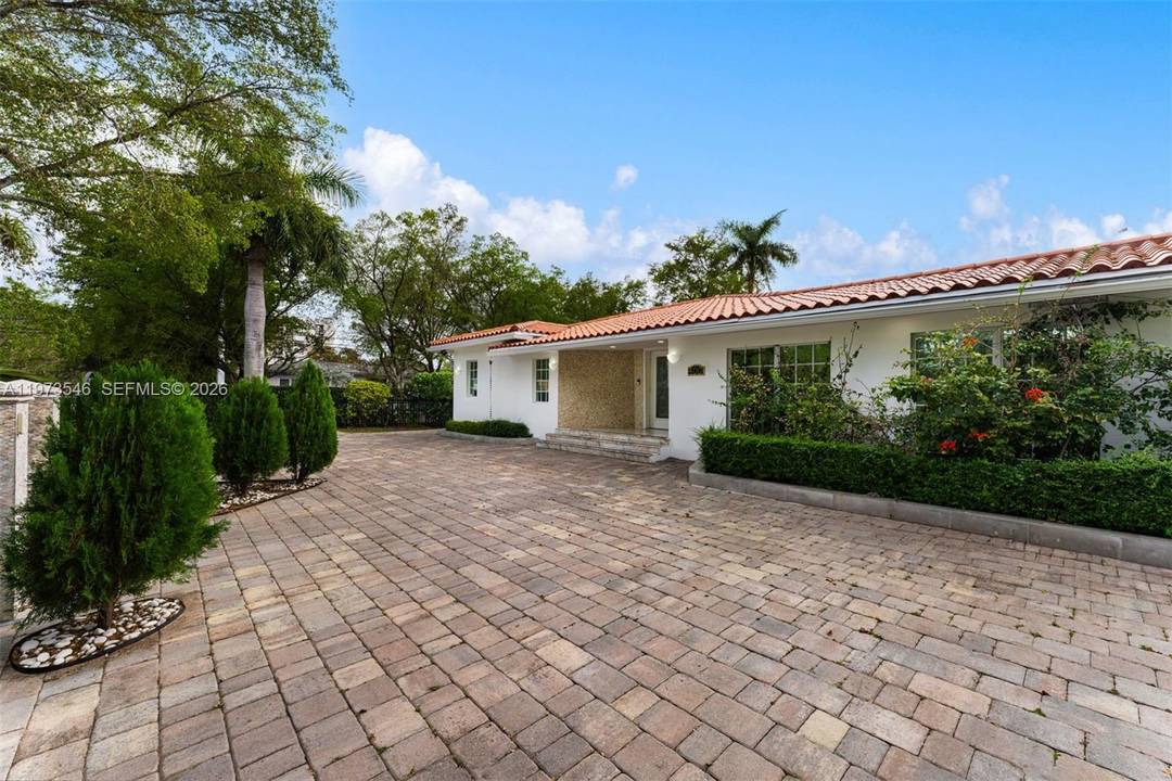 Welcome to 400 SW 24th Road, nestled on a quiet street in one of the most desirable pockets of The Roads.