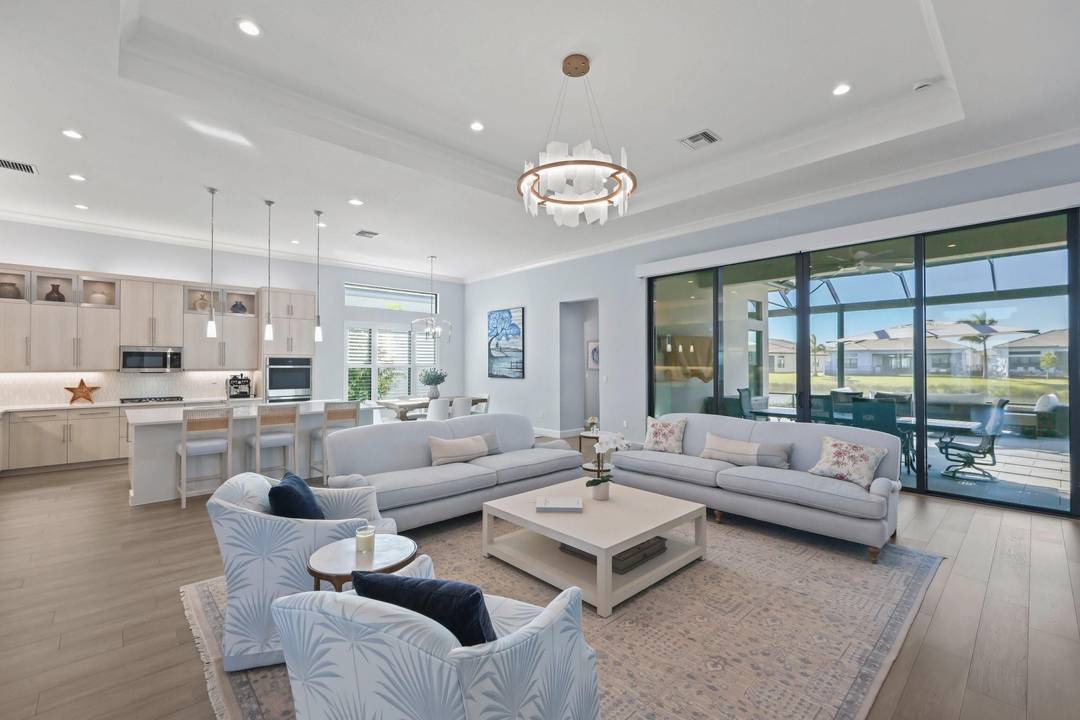 Coastal chic at Valencia Grand a 55 resort style community Lakefront expanded Carmel model boasting 3 BR Clubroom 4th BR Office Den Hobby room 4 BA.