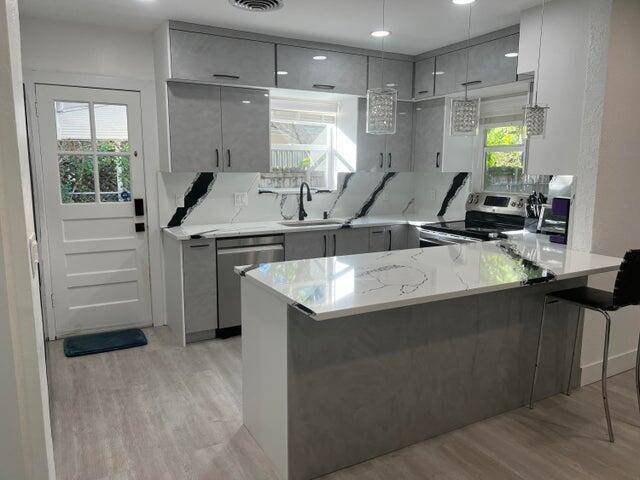 Fall in love with this beautifully upgraded home featuring a sleek Italian kitchen, stylish light gray vinyl flooring, and a spacious layout designed for comfort and entertaining.