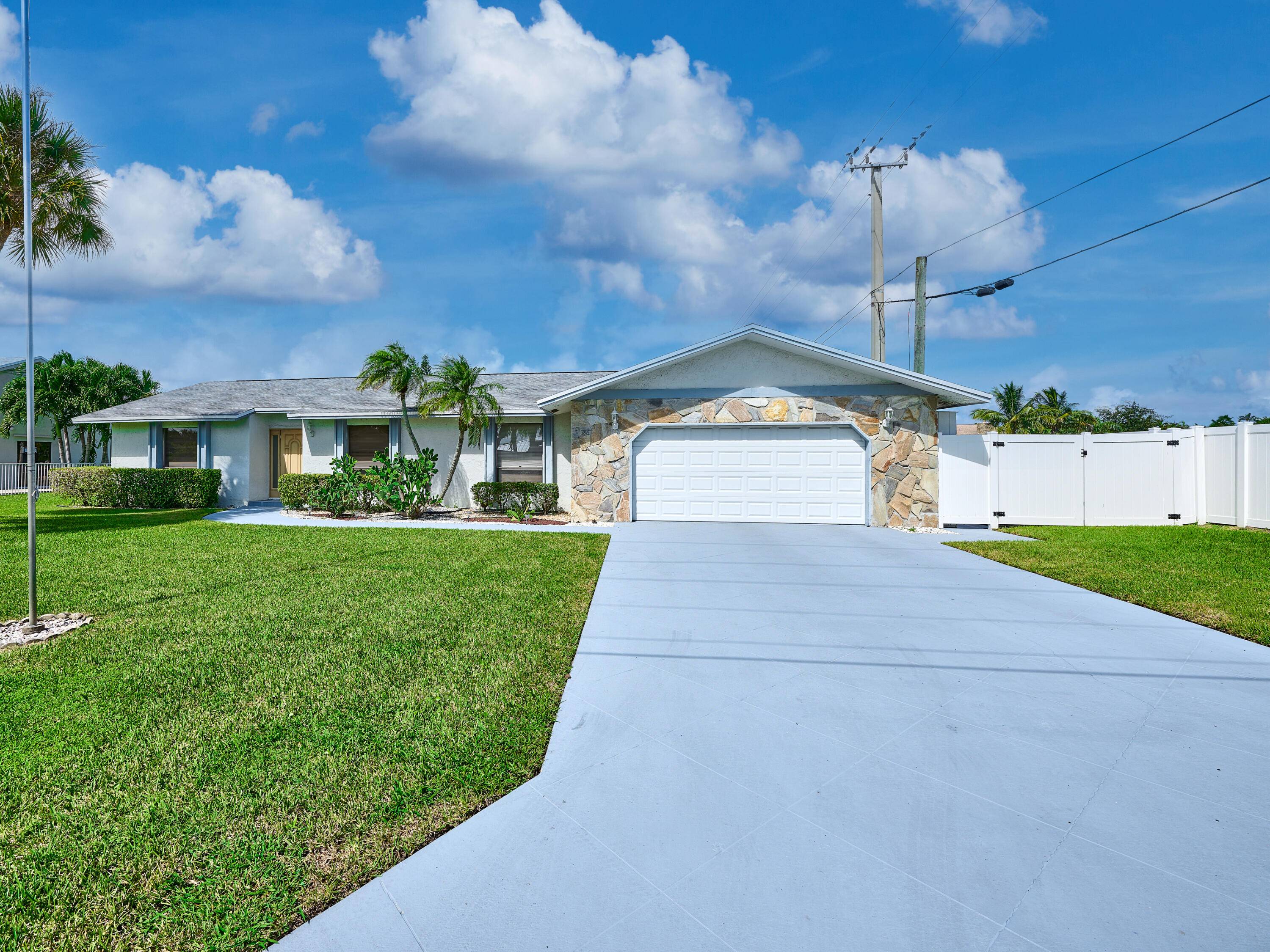 Gated Cypress Creek home in Boynton Beach featuring a new roof 2020, brand new A C 2025, and room for a boat or RV !