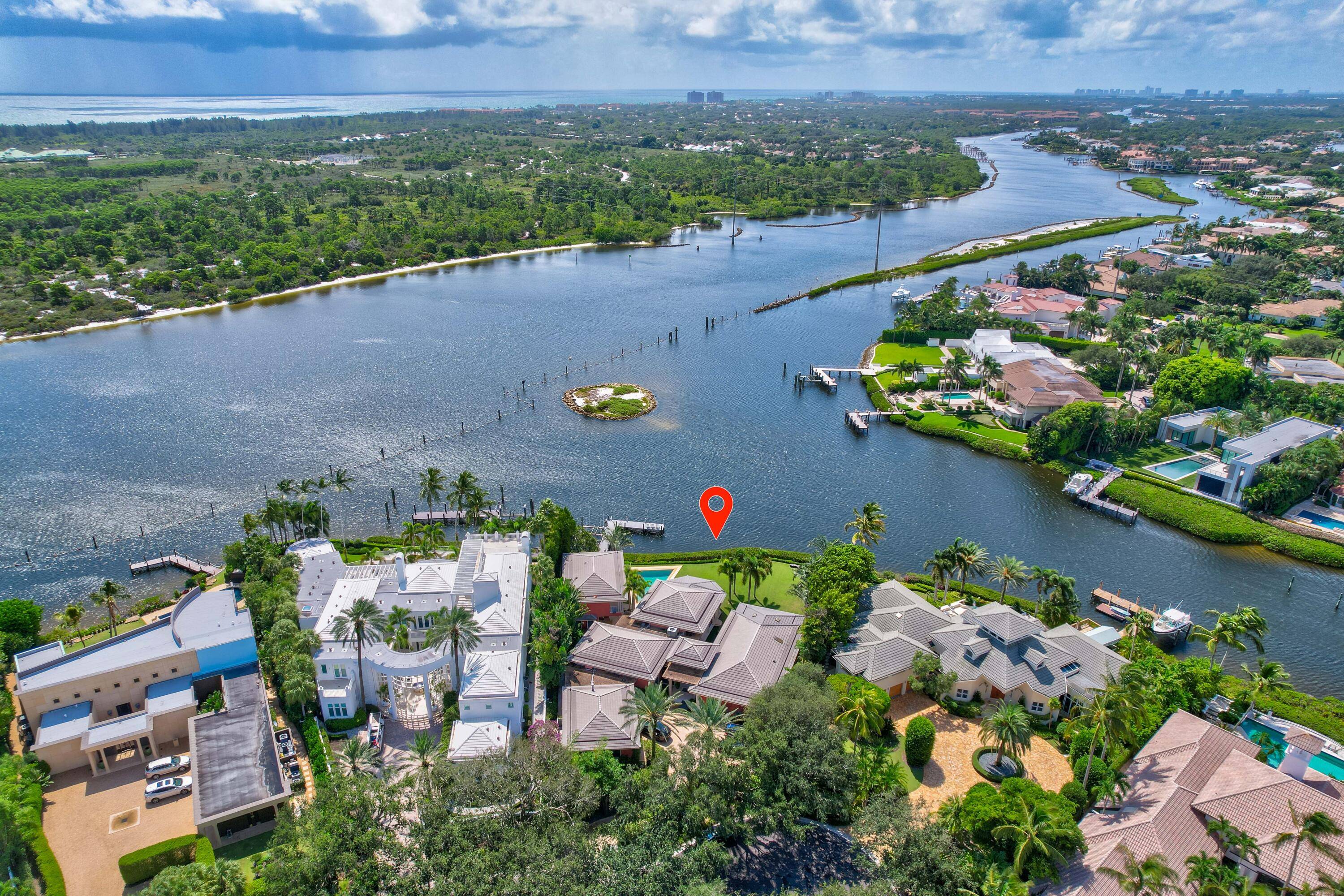 Elevate your lifestyle with this exceptional contemporary residence in Admirals Cove, boasting 180 feet of direct Intracoastal frontage.
