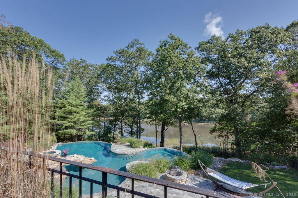 Resort like gated estate perched high above Sachem Head Road overlooking a saltwater tidal marsh nestled on 2.