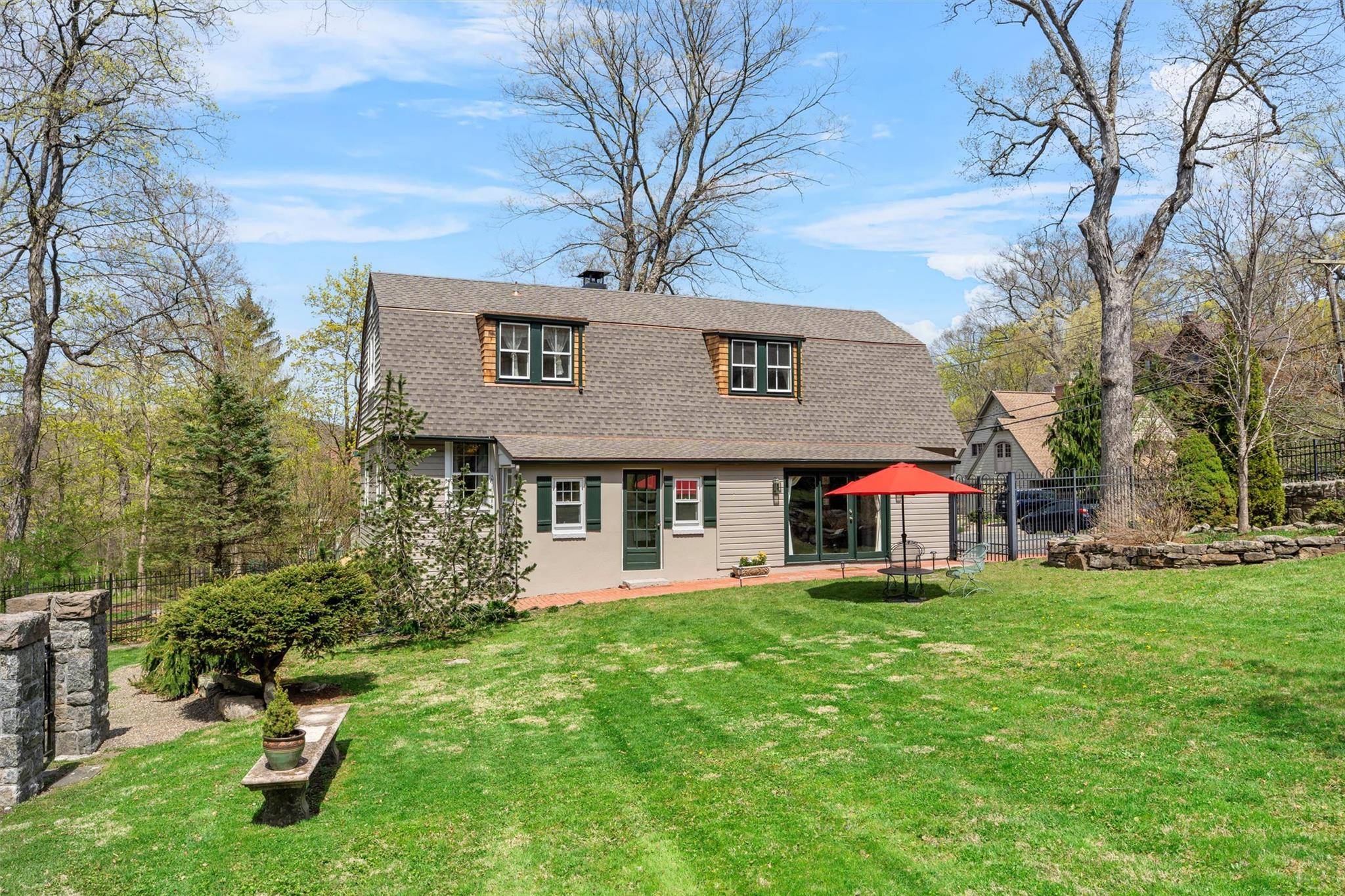 Nestled in the heart of gated, historic Tuxedo Park, this enchanting pre 1890 carriage house duplex unit on Clubhouse Road offers a perfect blend of timeless character and modern comfort.