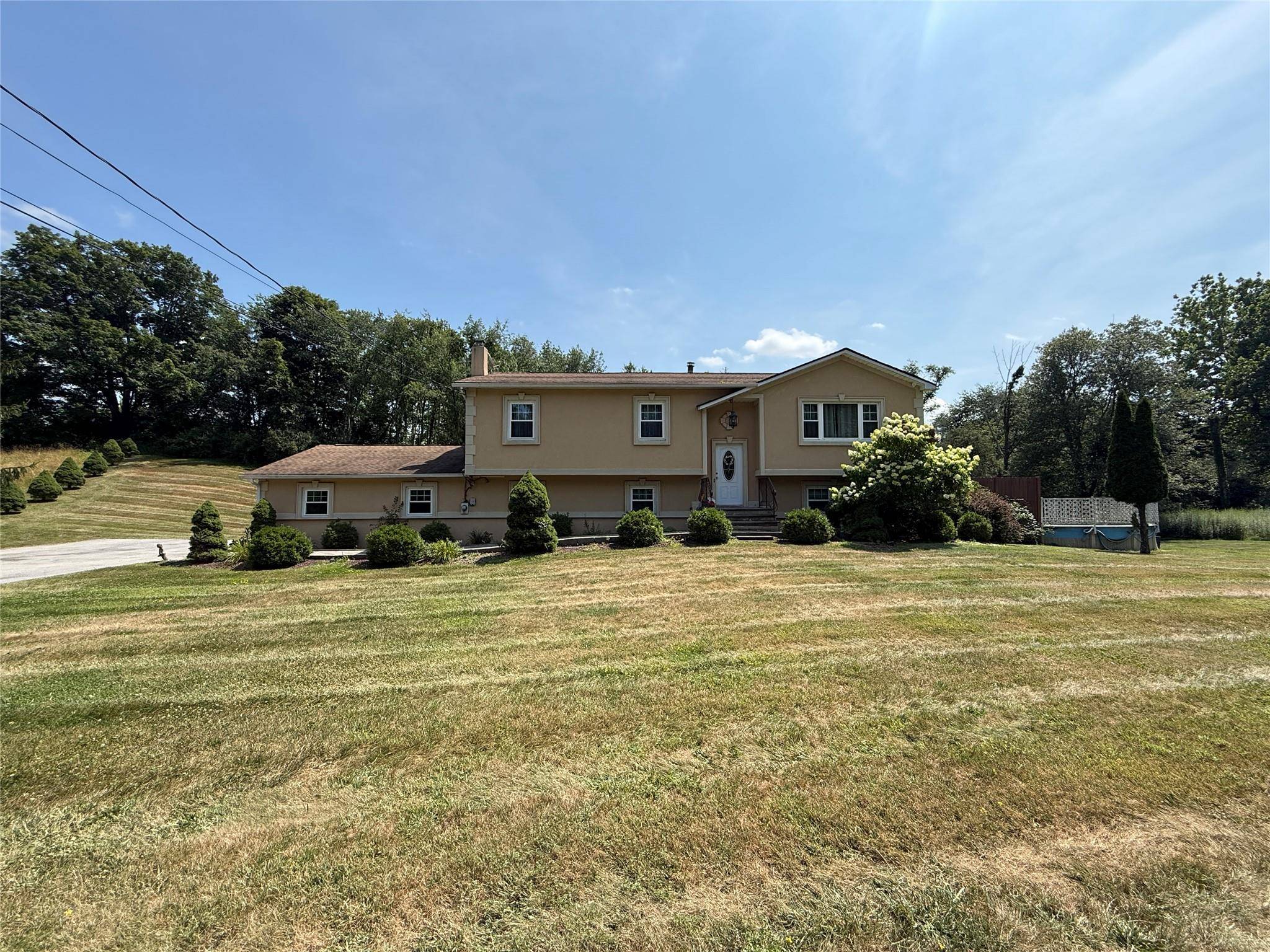 Owner requires proof of funds, for interior photos, kindly reach out to obtain photos Introducing a modern stucco faced raised ranch set on over an acre of picturesque land, complete ...