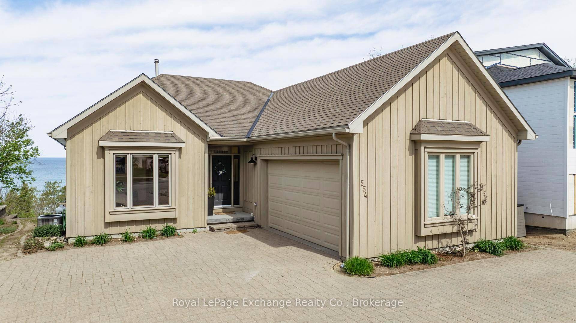 Spectacular lakefront with road between property with approximately 2700 sqft of living space and exquisite views on both levels !