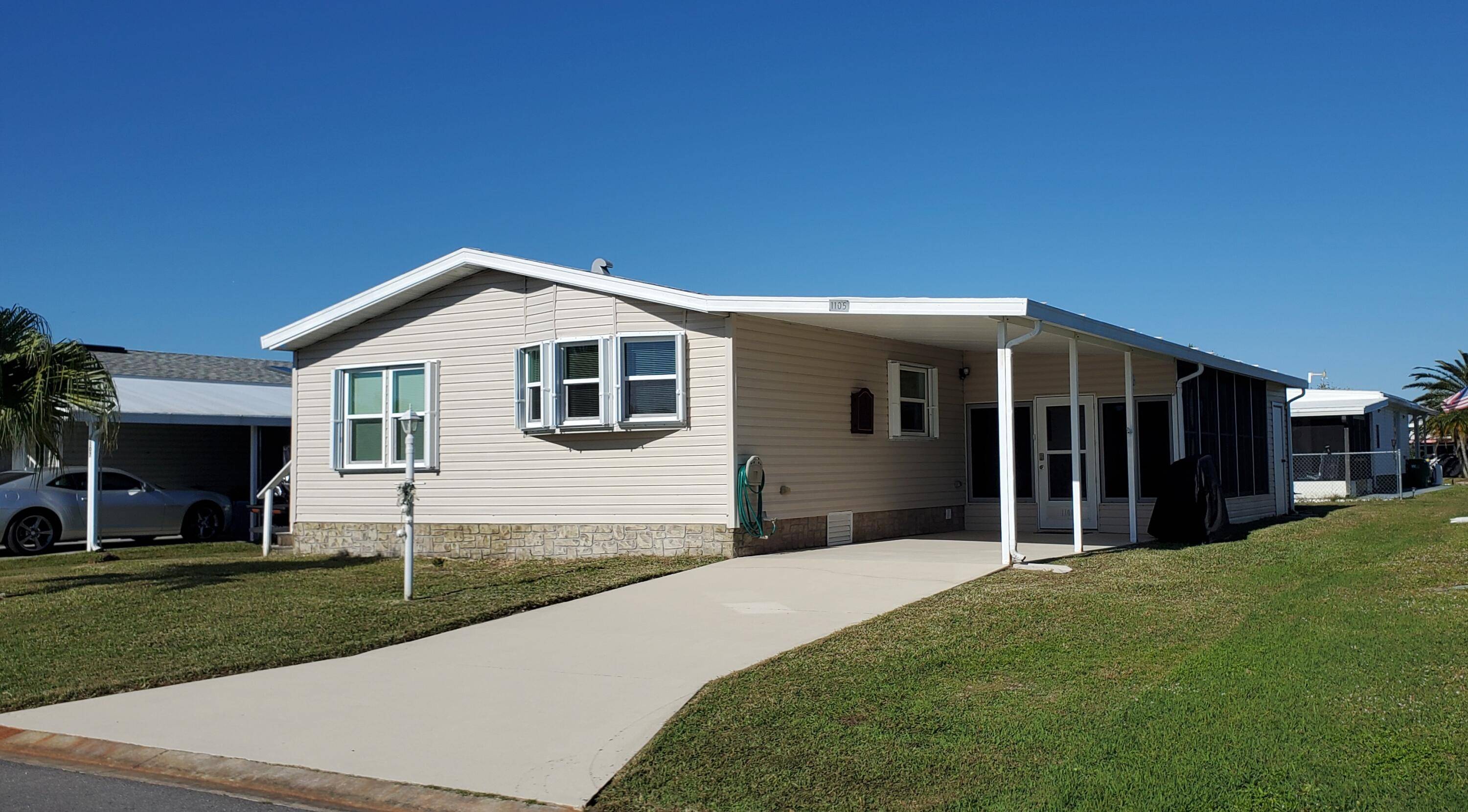 Renovated furnished cozy double wide home in Barefoot Bay perfect for year round living or vacation getaway featuring New roof installed in 2020, New double Pane Thermal Vinyl Windows, New ...