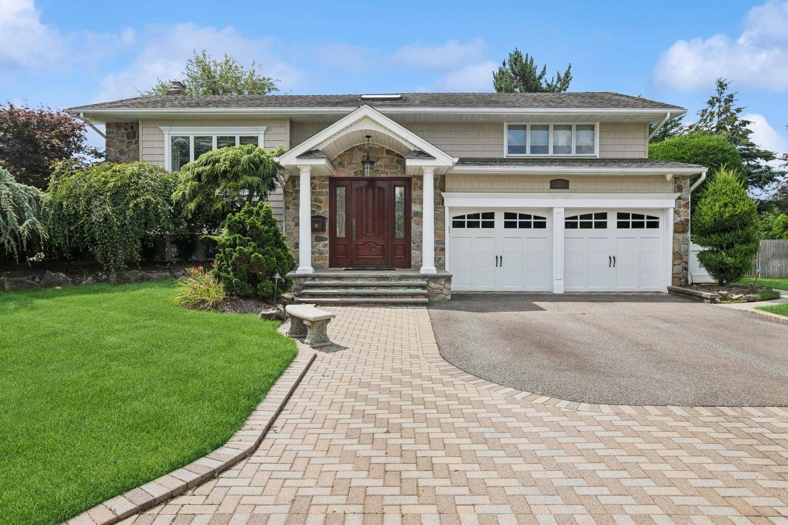 This tastefully renovated and expanded 3 bedroom and 3 bath Split Level home is nestled on a meticulously landscaped shy quarter acre.