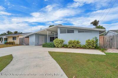 This beautifully upgraded vaulted ceiling mid century single family home in Palm Beach Gardens features 3 bedrooms and 2 bathrooms, with no HOA fees.
