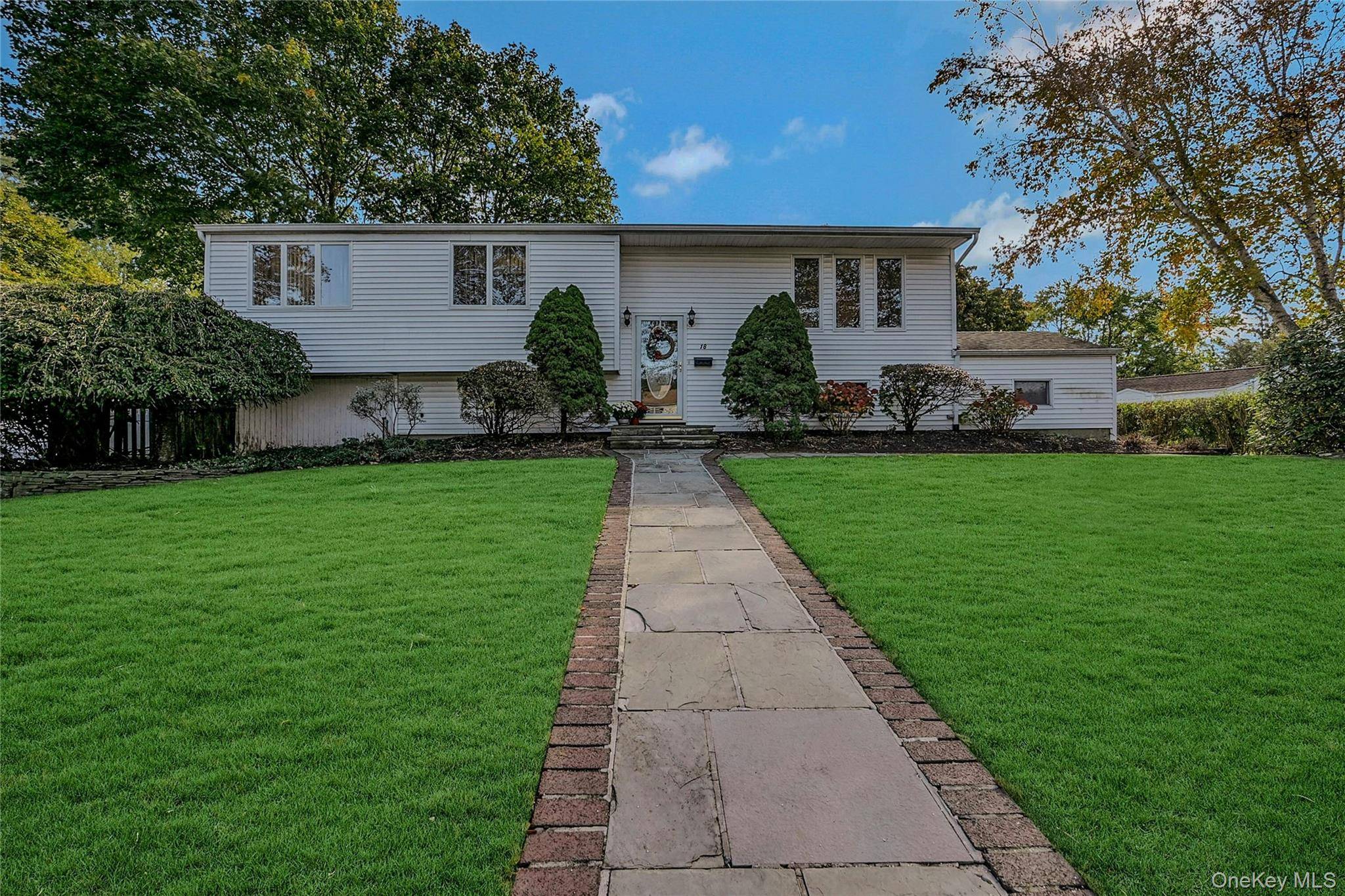 Bright and versatile 4 bedroom, 2 full bath Hi Ranch offering flexible living space with potential for multi generational or accessory apartment with proper permits.