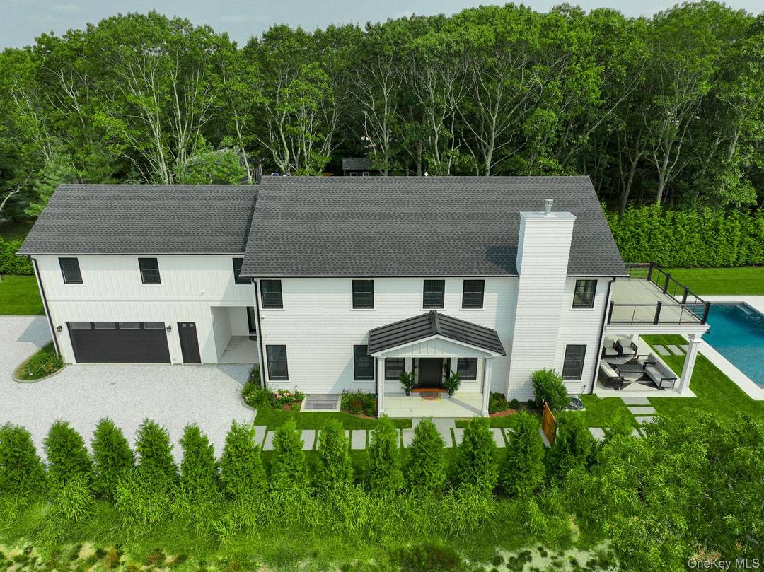 Discover refined Hamptons living in this newly completed residence set on a private, thoughtfully positioned lot in the hamlet of Quiogue.