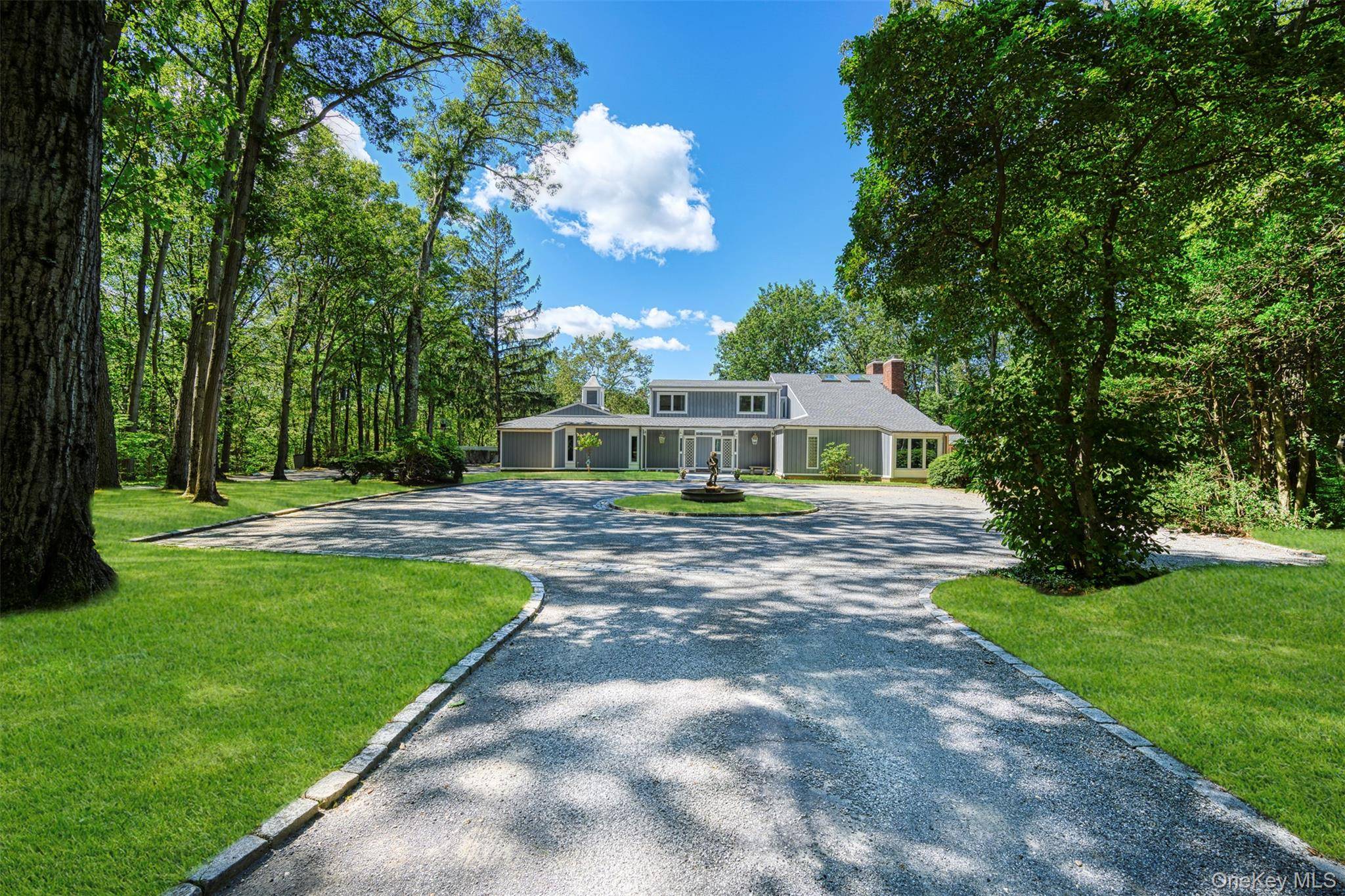 Custom residence perched on a hilltop on 4 private acres overlooking Oyster Bay Harbor.