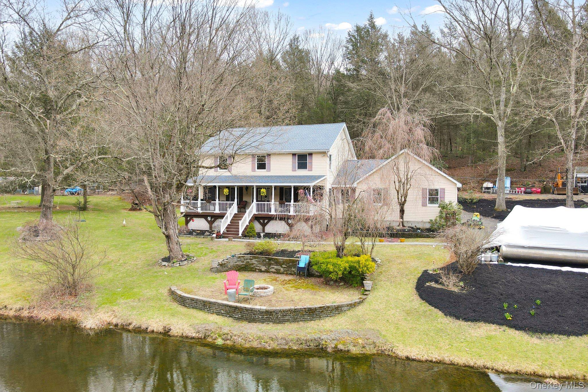 Stunning Colonial Home Nestled on A Little Over 20 Acres with a Serene Private Pond and Park like Surroundings !