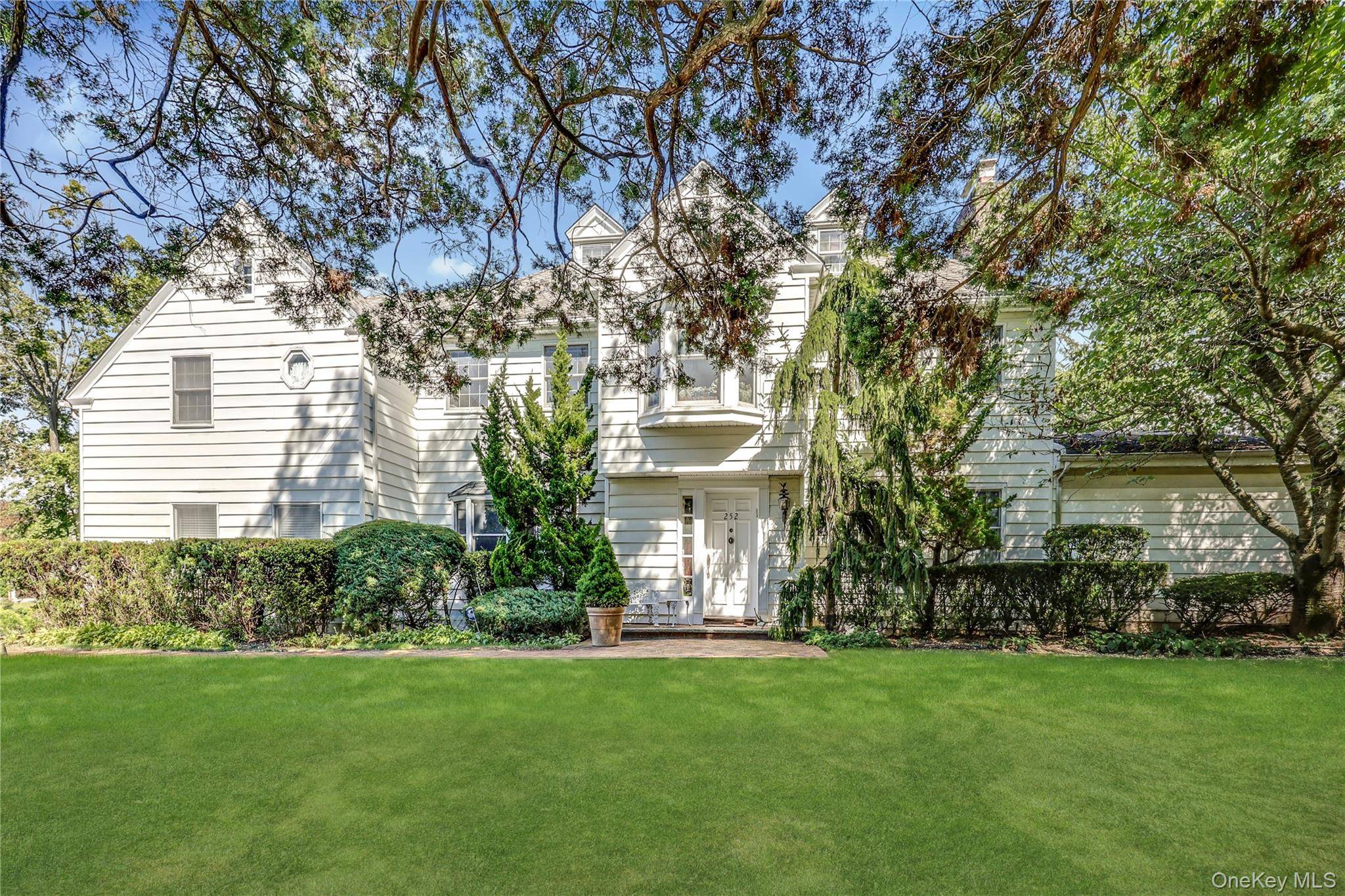 Welcome into this exceptional Hewlett Bay Park residence where timeless design meets modern comfort, set on 3 4 of an acre of magnificent grounds.