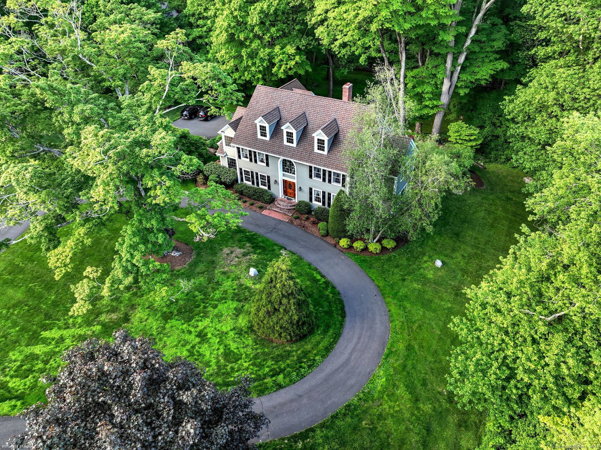 A long and winding drive leads to this exceptional colonial sited under a grand old oak tree.