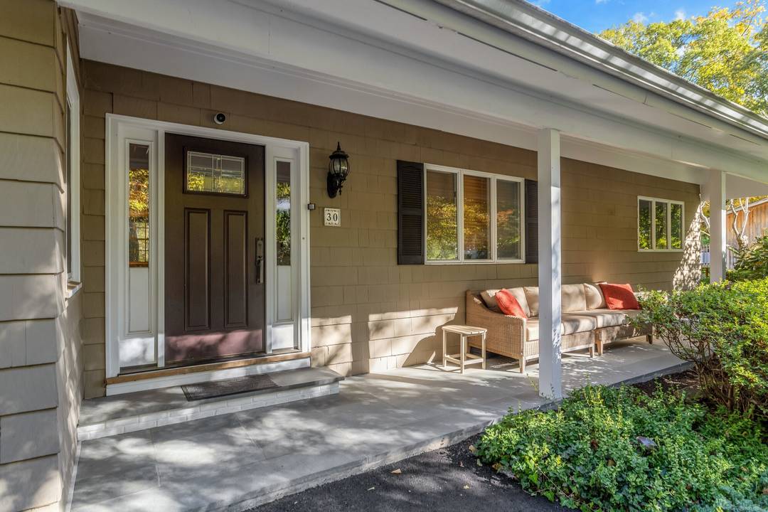 Experience refined living in this beautifully appointed 5 bedroom, 3 bath ranch, privately nestled behind lush, mature landscaping on nearly 1.