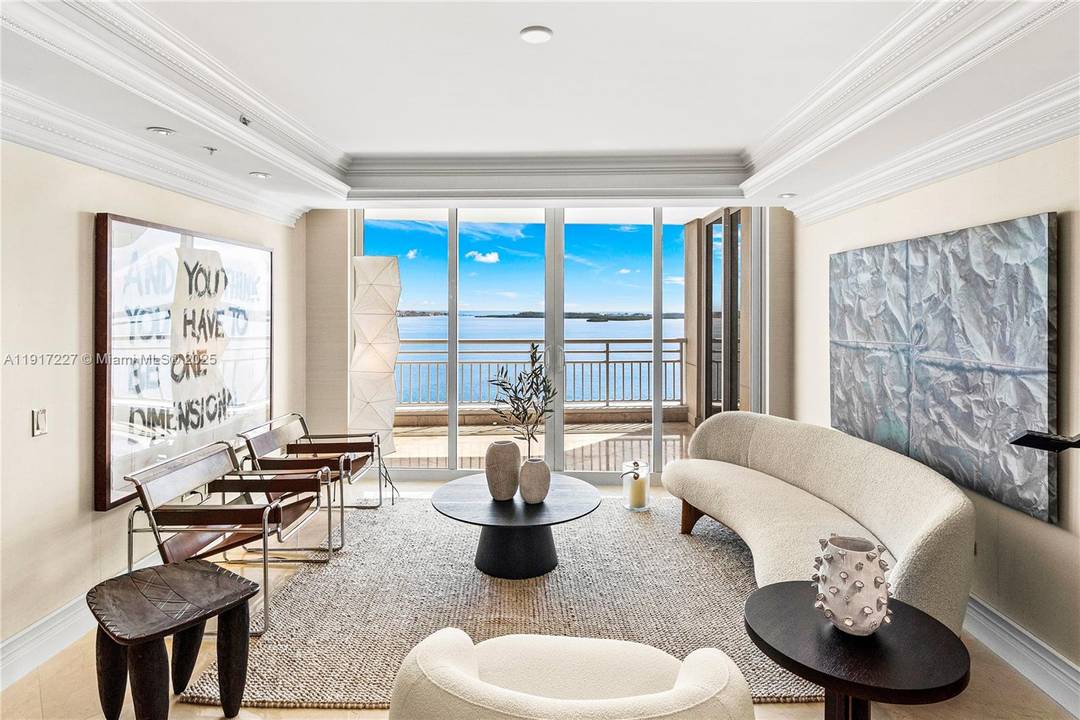 Beauty on the Bay ! Situated in the easternmost corner of exclusive gated Brickell Key, this custom residence redefines modern coastal elegance.