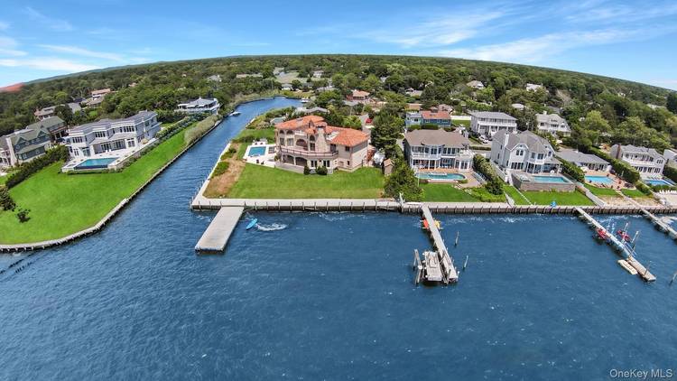 This stunning Mediterranean style waterfront home is the perfect summer retreat, offering breathtaking views over Moriches Bay.
