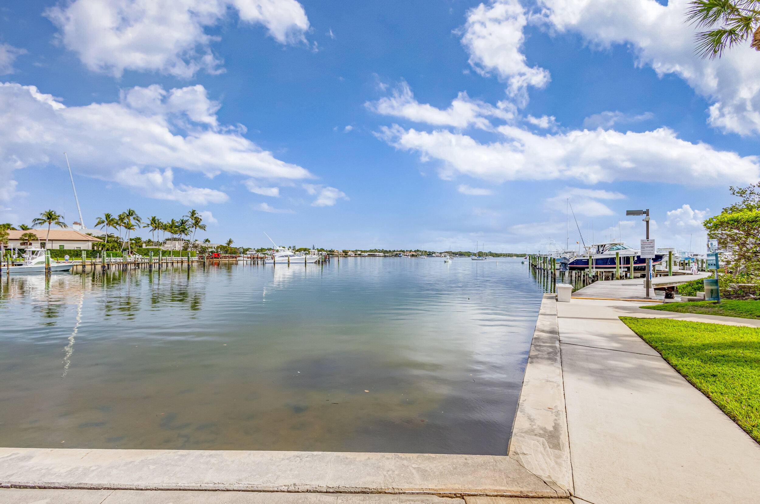 Welcome to your waterfront oasis at Twelve Oaks, a premier gated community in North Palm Beach.