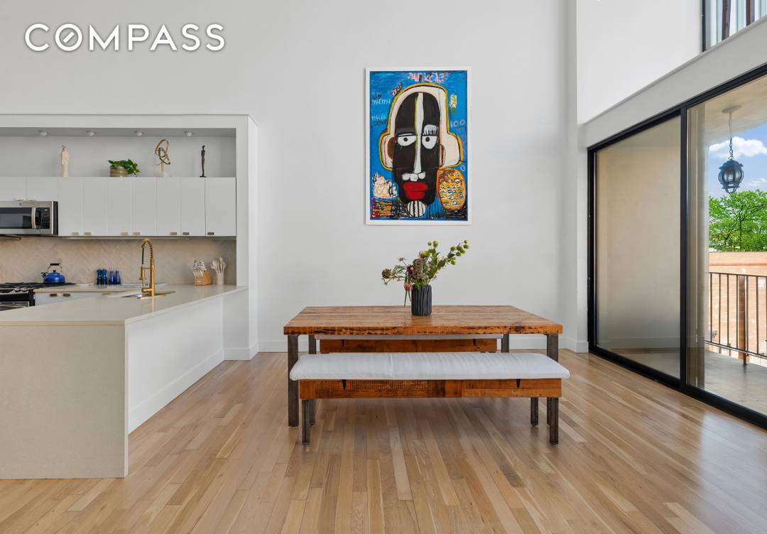 A rare architectural duplex with 24 foot ceilings, panoramic skyline views, and three private balconies available now in Prime Fort Greene.