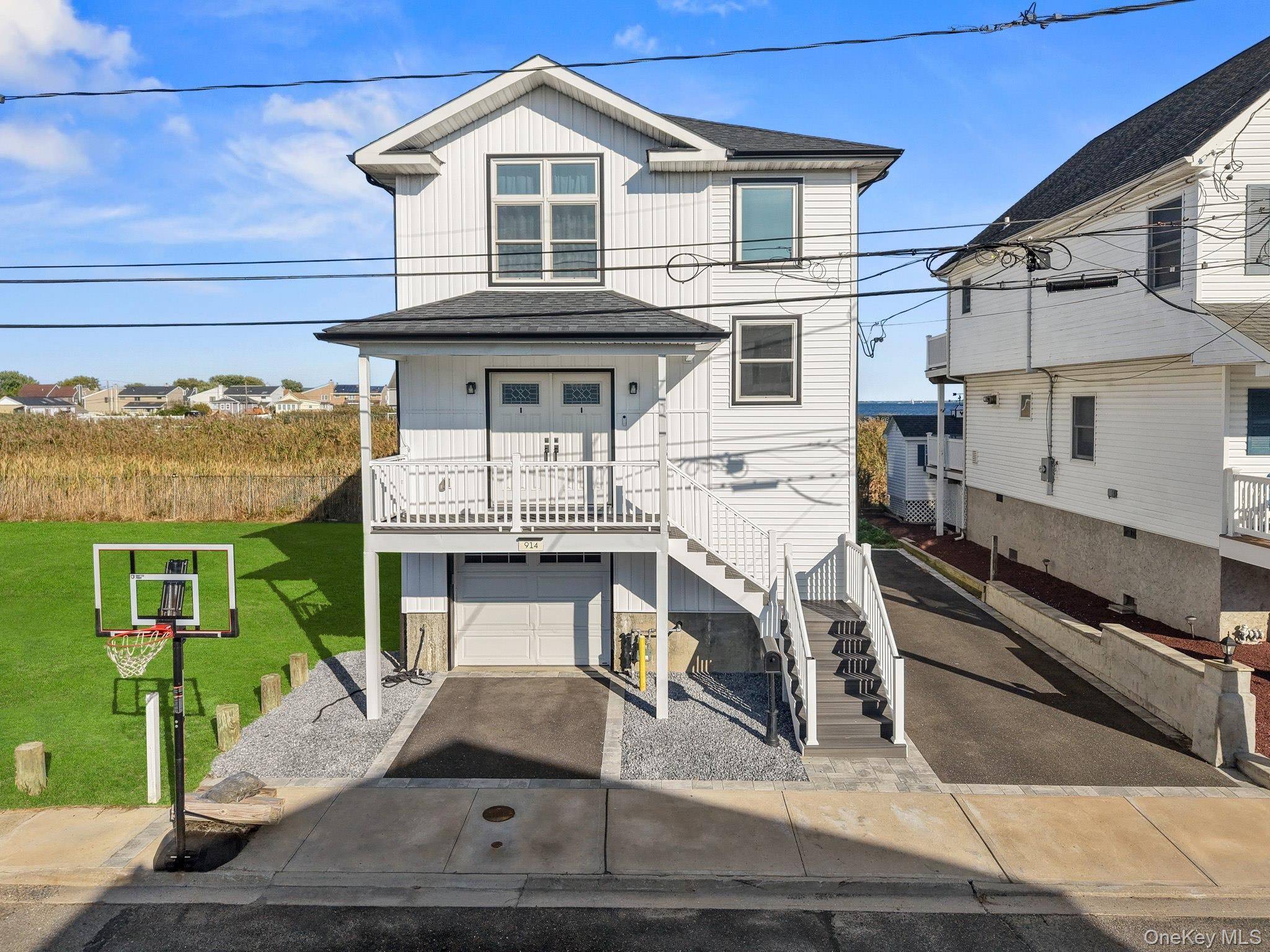 Experience luxury waterfront living in this 2023 contemporary new construction in Lindenhurst Village !