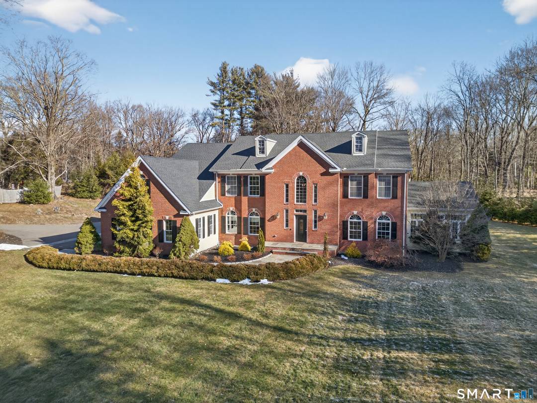 The commanding presence of this stately brick Colonial will take your breath away.