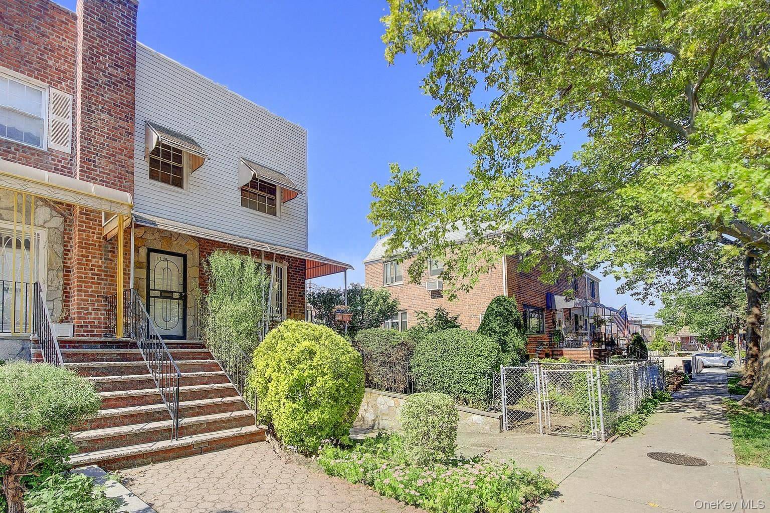 Charming semi detached home on a quiet street featuring a welcoming front porch and private driveway.