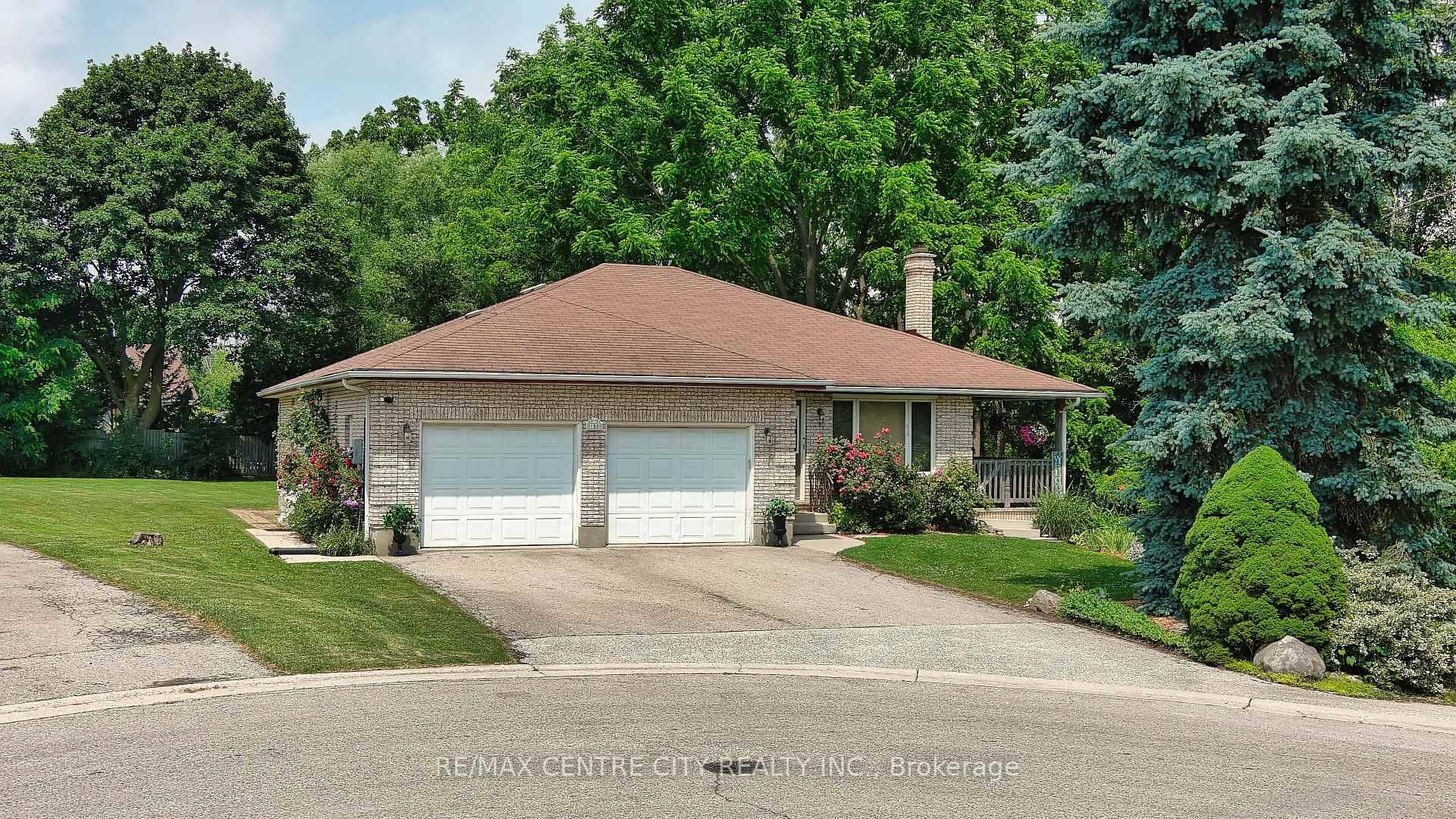 Immaculate brick bungalow with an In law suite, double car garage amp ; detached shop on a large double lot.