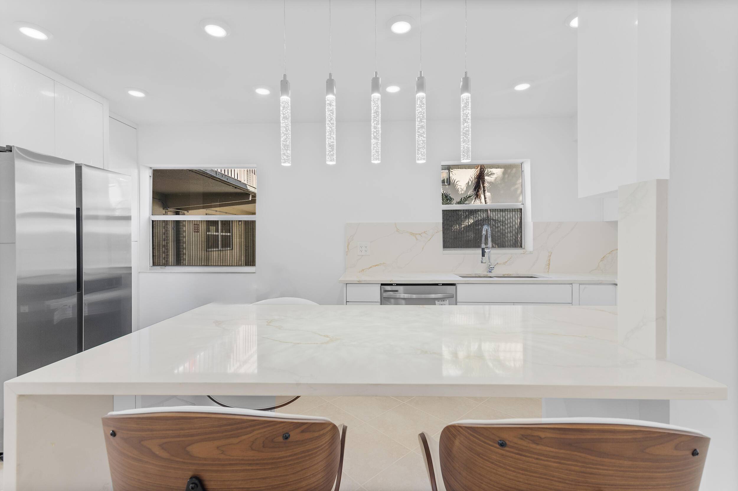 This completely remodeled 2 bed 2 bath Ground floor condo offers modern elegance and breathtaking lake views from the living room.