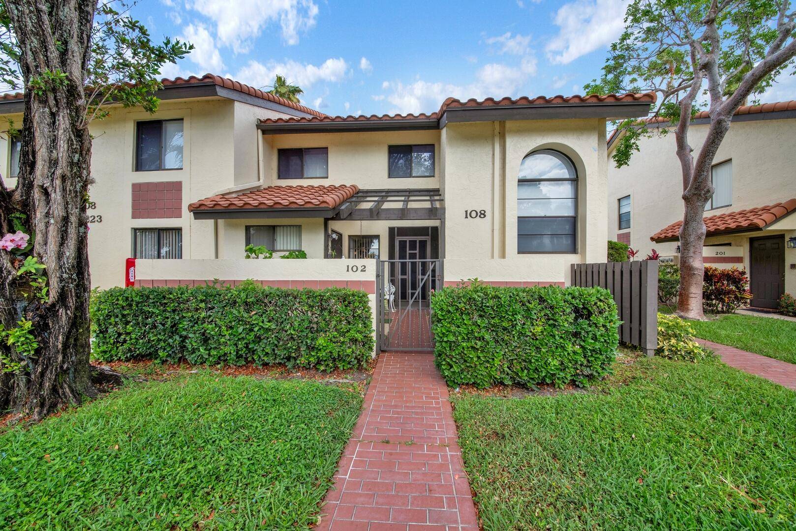 Step into serene, easy living with this beautifully updated first floor, corner unit in the highly desirable Palm Chase Lakes community.