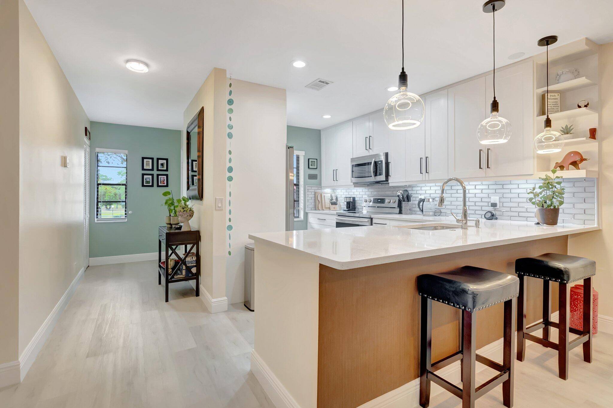 Experience breathtaking lakefront living in this stunning 2 bedroom, 2 bathroom condo in the highly sought after Cypresses of Boca Lago !