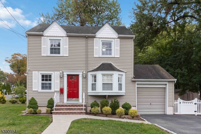 Fall in love with this charming 3 bedroom, 2 bath Colonial perfectly set on a desirable corner lot !
