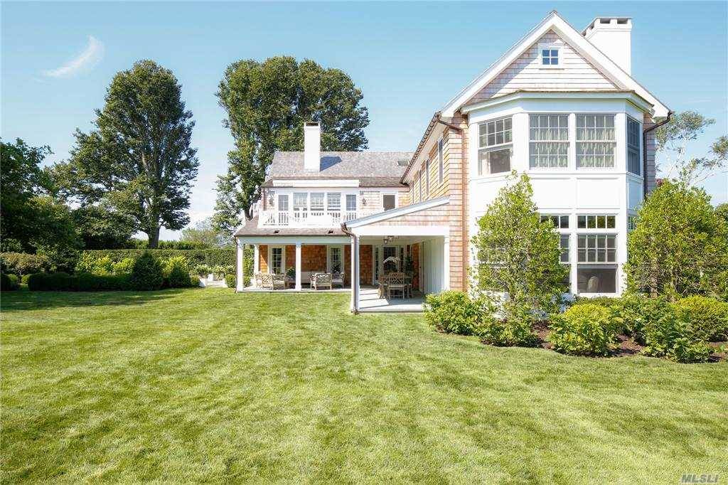 Graceful and refined living in Georgica, South of the Highway in East Hampton, takes place on one and a half acres.